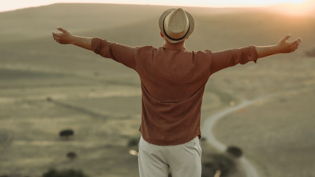 pexels photo 19179821 19179821 Back view of a man enjoying freedom and nature in a picturesque valley at sunset.